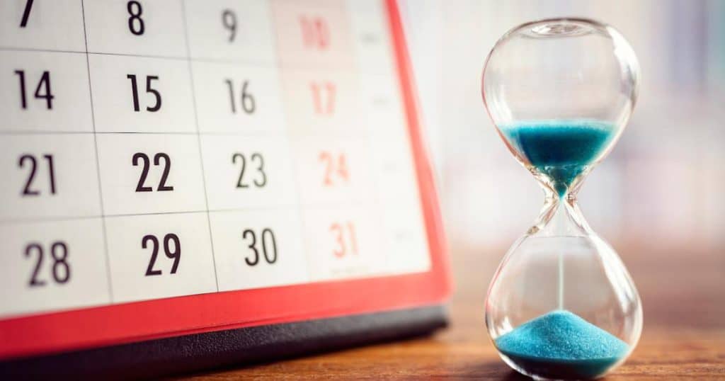 hour glass with a calendar on the side